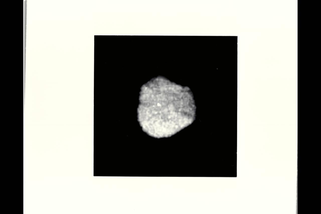 P-34681 Range: 870,000 kilometers (540,000 miles) This image of Neptune's irregularly-shaped satellite 1989N1 taken by Voyager 2 shows a resolution of 8 kilometers (5 miles) per pixel. The satellite has an average radius of about 200 kilometers (120 miles) and is uniformly dark with an albedo of about 6 percent. The irregular shape suggests that 1989N1 has been cold and rigid throughout its history and subject to significant impact cratering.