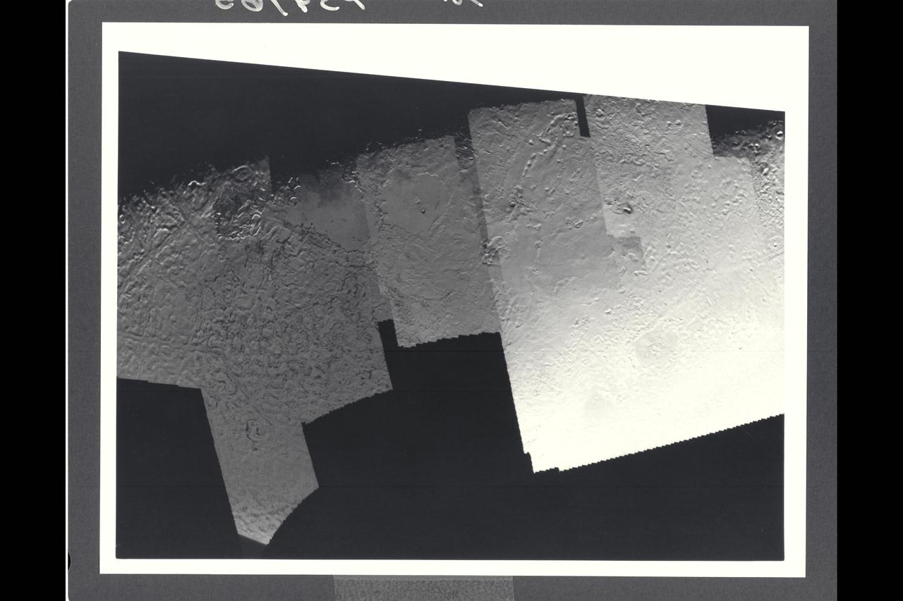 Range : 40,000 km (24,8000 mi.) This picture of Triton is a mosaic of the highest resolution images taken by Voyager 2. The mosaic is superimposed on the lower-resolution mapping images taken about 2 hours earlier in order to fill in gaps between high-resolution images. The smallest features that can be seen on the images are about 0.8 km (0.5 mi.) across. The terminator (line separation day and night) is at the top of the picture and is centered at about 30 degrees north latitude and 330 degrees longitude. These highest-resolution images were targeted for the terminator region to show details of the topography by the shadows it casts. Near the center of the picture is a depression filled with smooth plains that are probably ices which were once erupted in a fluid state. The depth of the depression is about 300 meters (900 feet) and the prominent fresh impact crater on its floor is about 20 km (12 mi.) in diameter and about 1 km (0.6 mi.) deep. On the right is a elongate crater with adjacent dark deposits about it. This feature may be an explosive eruption vent formed by gaps within the ice. The linear structure on the lest is probably a fracture along which fresh ice has been extruded.