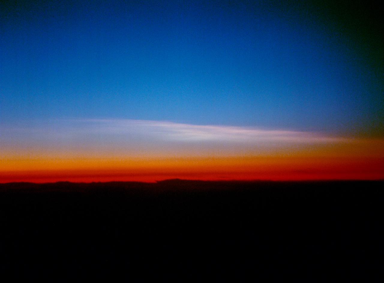 Arctic Ozone Expedition Stavanger Norway These clouds in the polar regions north of Stravanger, Norway are representative of what are called 'Type 1' and Type 2' polar stratospheric clouds. Type 1 are seen in the lower portion and consist of cloud particles comprised of nitrogen trihydrates. Seen edge-on as in this view, they appear as a thin dark orange or brown layer. Multiple layering can be seen. The Type 2 clouds are above and consist mostly of water molecules frozen as ice. The size of the particles in Type 2 clouds, the water-ice clouds, are much larger than the particle size of the Type 1 clouds - which are on the order of the wavelength of light.