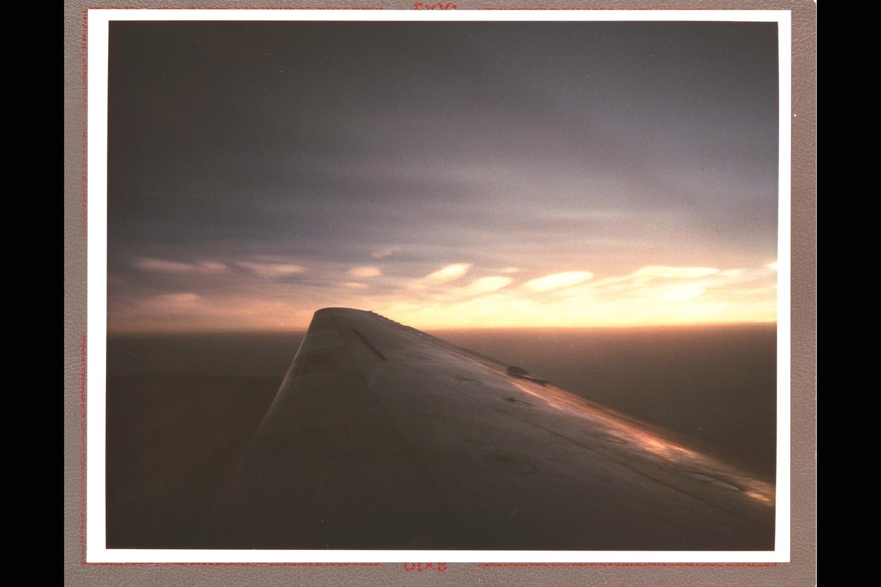Airborne Arctic Stratospheric (Ozone) Expedition Stavanger Norway Jan-Feb 1989: The clouds seen from the NASA DC-8 aircraft at nearly 39,000 feet in the polar regions north of Stravanger, Norway, are representative of what are called 'Type II' polar stratospheric clouds. This type consists mostly of water molecules frozen as ice. These particular clouds are also exhibiting what is called orographic effects - the clouds have taken on a wave-like form because of motion associated with underlying topographic features of the earth's surface; in this case, some mountains in Iceland.