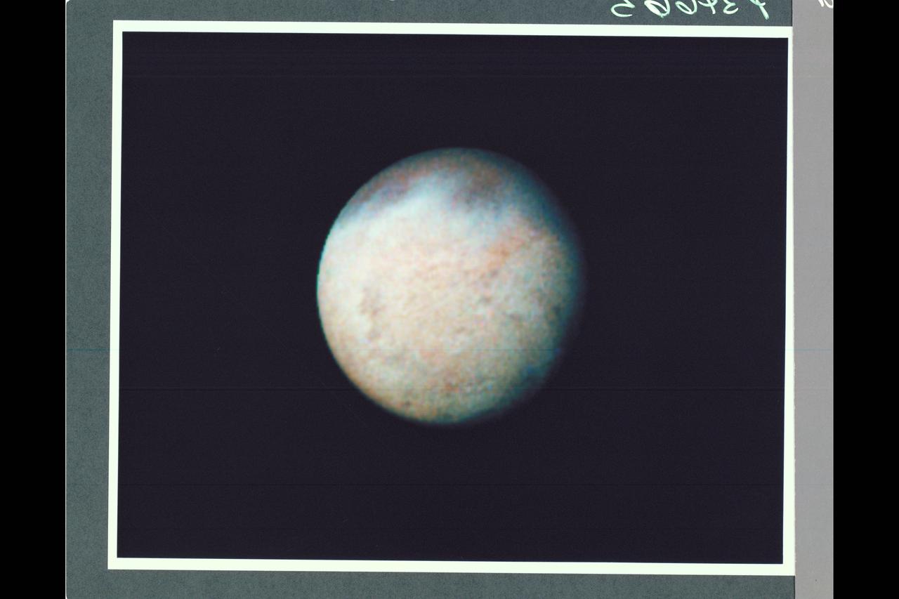P-34665 This false color Voyager 2 image of Neptune's satellite Triton, is a composite of three images taken through ultraviolet, green, and viloet filters. The smallest resolvable features are about 47 km., or 29 miles accross. Mottling in the bright southern hemisphere may be the result of topography, if Triton's crust is predominently water ice, which is rigid at Triton's surface temperature. Alternatively, the mottling could be due to markings on a smooth surface, if the crust is composed of nitrogen, carbon monoxide, or methane ice, since they are soft at the same temperature.