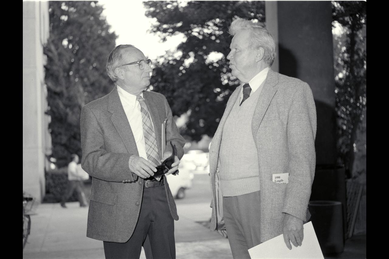 Adrian Mandel and Harvard Lomax (right) follow the ceremony honor each for 45 years of service