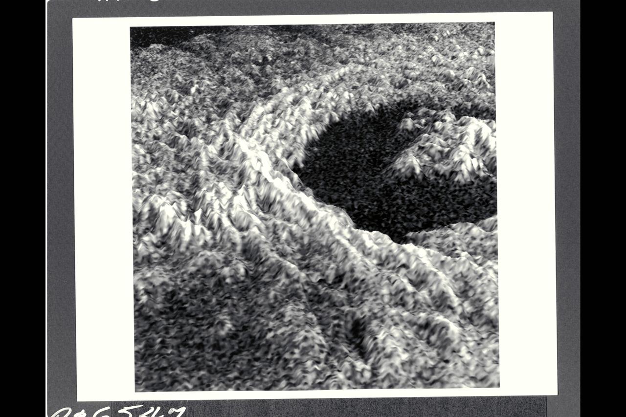 This three-dimensional representation of brightness variations in a Magellan radar image of Golubkina crater enhances the structural features of the crater.  Golubkina is 34 kimometers (20.4 mi.) in diameter, and is located at about 60.5 degrees north latitude, 287.2 degrees east longitude.  Golubkina is characterized by  terraced inner walls and a central peak, typical of large impact craters on the Earth, Moon and Mars.  The terraced inner walls form at late stages in the formation of an impact crater, due to collapse of the initial cavity formed by the meterorite impact.  The central peak forms due to rebound of the inner crater floor.