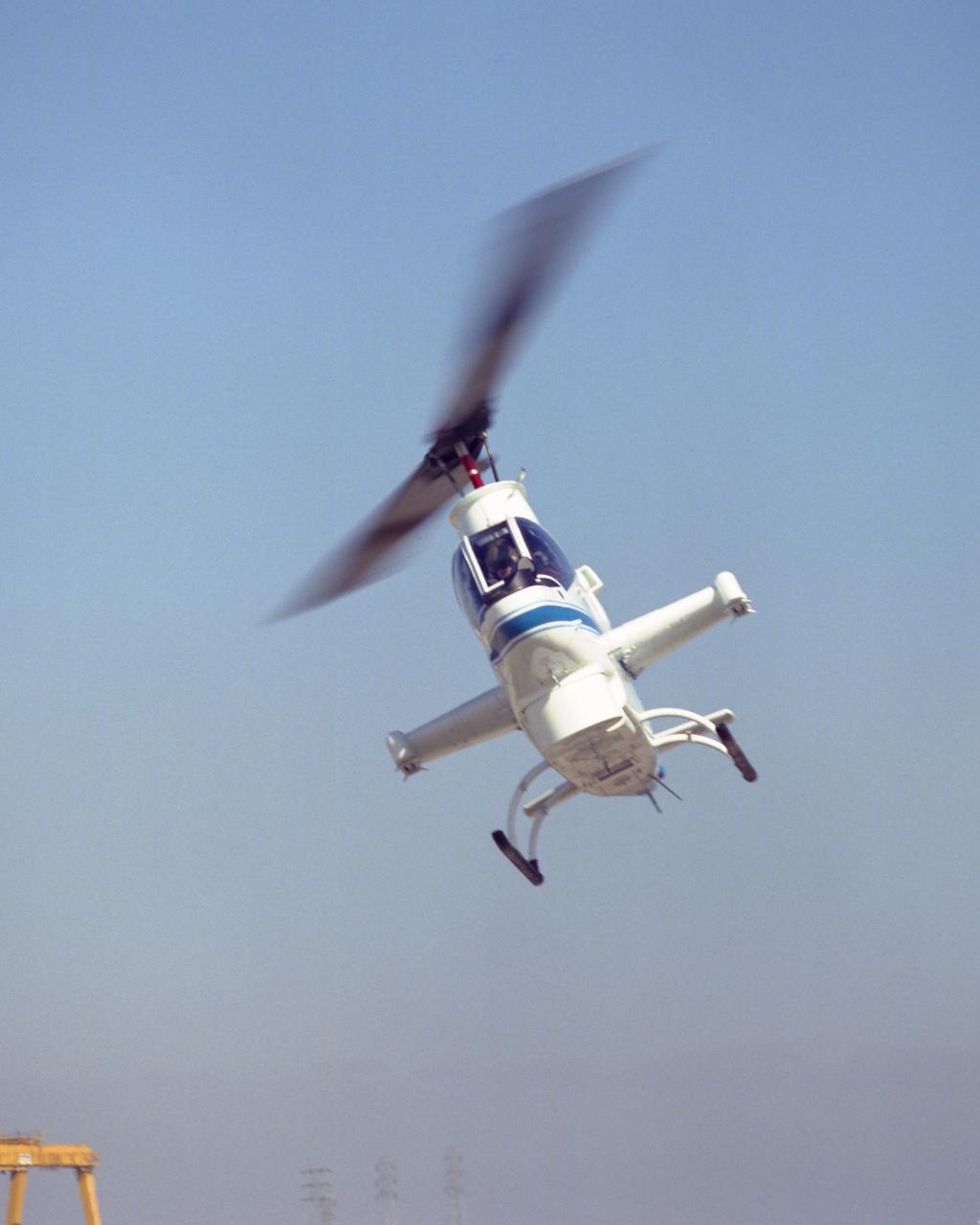 Cobra AH-1G (NASA-736) helicopter hovering on Ames ramp