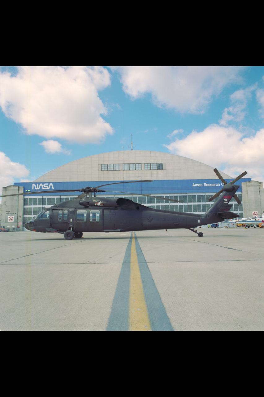 UH-60 (NASA-750) on Ames ramp - side view in front of hangar