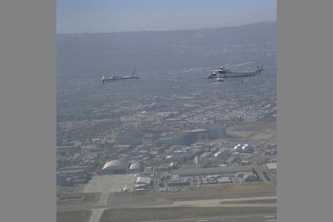 YO-3A (NASA-718) and SH-3G (NASA-735) in flight over Ames on way to Crows Landing during Helicopter Airborne Laser Positioning System flight tests