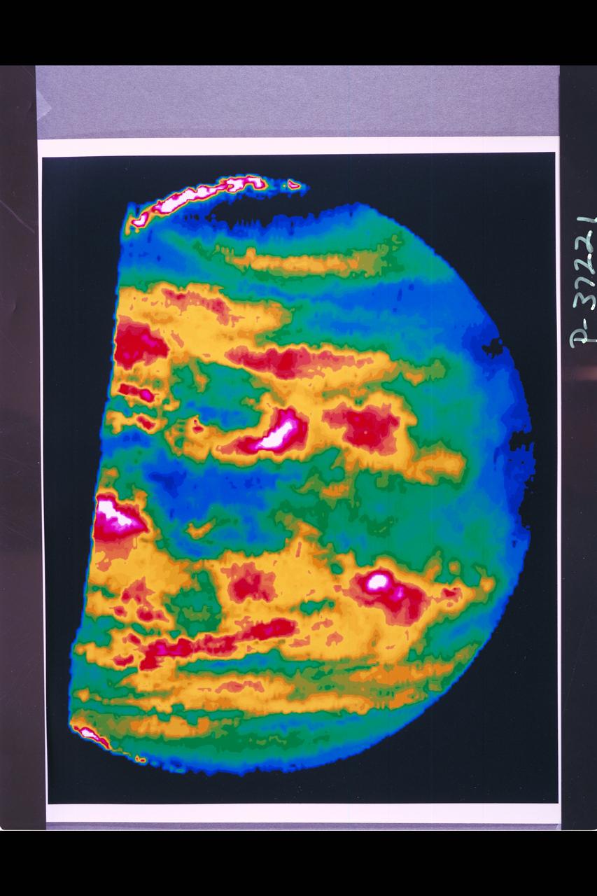 Range :  60,000 miles This image is a false-color version of a near- infrared map of lower-level clouds on the night side of Venus, obtained by the Near Infrared Mapping Spectrometer aboard Galileo.  Taken at an infrared wavelength of 2.3 microns (about three times the longest wavelength visible to the human eye) the map shows the turbulent, cloudy middle atmosphere some 30-33 miles above the surface, 6-10 miles below the visible cloudtops.  The image shows the radiant heat from the lower atmosphere (about 400 degrees F) shining through the sulfuric acid clouds, which appear as much as 10 times darker than the bright gaps between clouds.  The colors indicate relative cloud transparency; white and red show thin cloud regions, while black and blue represent relatively this clouds.  This cloud layer is at about 170 degrees F., at a pressure about 1/2 Earth's atmospheric pressure.  About 2/3 of the dark hemisphere is visible, centered on longitude 350 West, with bright slivers of daylit high clouds visible at top and bottom left.  Near the equator, the clouds appear fluffy and blocky; farther north, they are stretched out into East-West filaments by winds estimated at more than 150 mph, while the poles are capped by thick clouds at this altitude.  The Near Infrared Mapping Spectrometer (NIMS) on the Galileo is a combined mapping (imaging) and spectral instrument.  It can sense 408 contiguous wavelengths from 0.7 microns (deep red) to 5.2 microns, and can construct a map or image by mechanical scanning.  It can spectroscopic-ally analyze atmospheres and surfaces and construct thermal and chemical maps.  Designed and operated by scientists and engineers at the JPL, NIMS involves 15 scientists in the US, England and France.