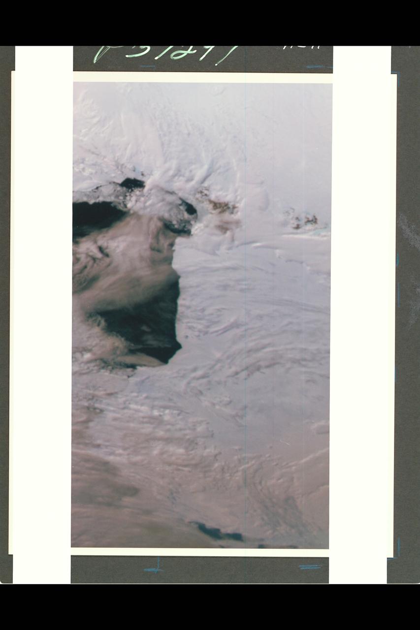 This color picture of Antarctica is one part of a mosaic of pictures covering the entire polar continent taken during the hours following Galileo's historic first encounter with its home planet. The view shows the Ross Ice Shelf to the right and its border with the sea. An occasional mountain can be seen poking through the ice near the McMurdo Station. It is late spring in Antarctica, so the sun never sets on the frigid, icy continent. This picture was taken about 6:20 pm PST. From top to bottom, the frame looks across about half of Antarctica.