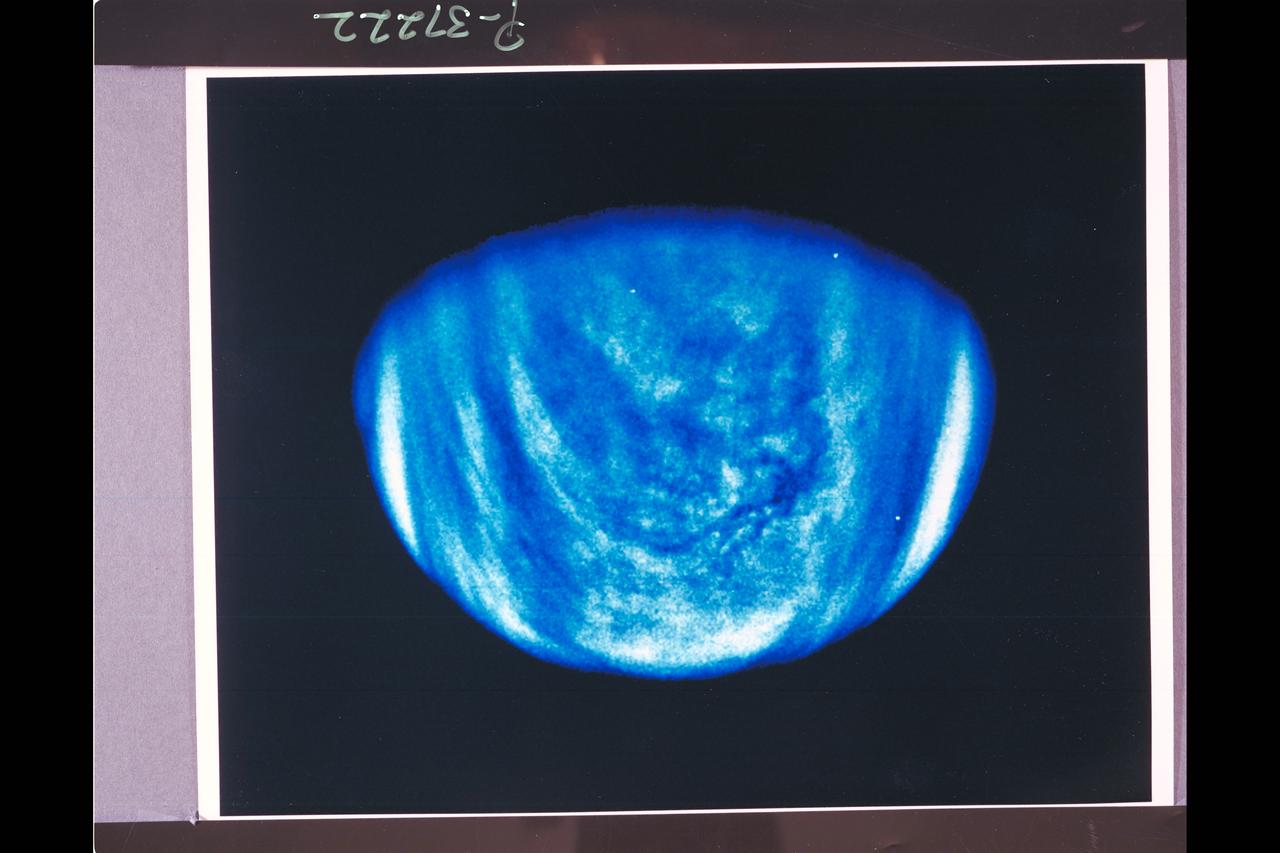 Range : 1.7 million miles This photo of Venus was taken by the Galileo spacecraft's Solid State Imaging System. A high-pass spatial filter has been applied in order to emphasize the smaller-scale cloud features, and the rendition has been colorized to a bluish hue in order to emphasize the subtle contrasts in the cloud markings and to indicate how it was taken through a violet filter. The sulfuric acid clouds indicate considerable convective activity, in the equatorial regions of the planet to the left and downwind of the subsolar point (afternoon on Venus), They are analogous to 'fair weather clouds' on Earth. The filamentary dark features visible in the colorized image are here revealed to be composed of several dark nodules, like strings on a bead, each about 60 miles across.