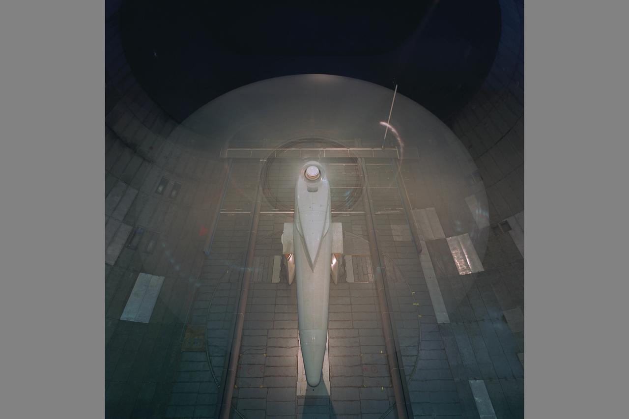 Sikorsky Bearingless Main rotor (SBMR) mounted on the Ames Rotor Test Apparatus (RTA) during testing in the NASA Ames 40x80ft Subsonic Wind Tunnel, test-584. Rotors in motion.