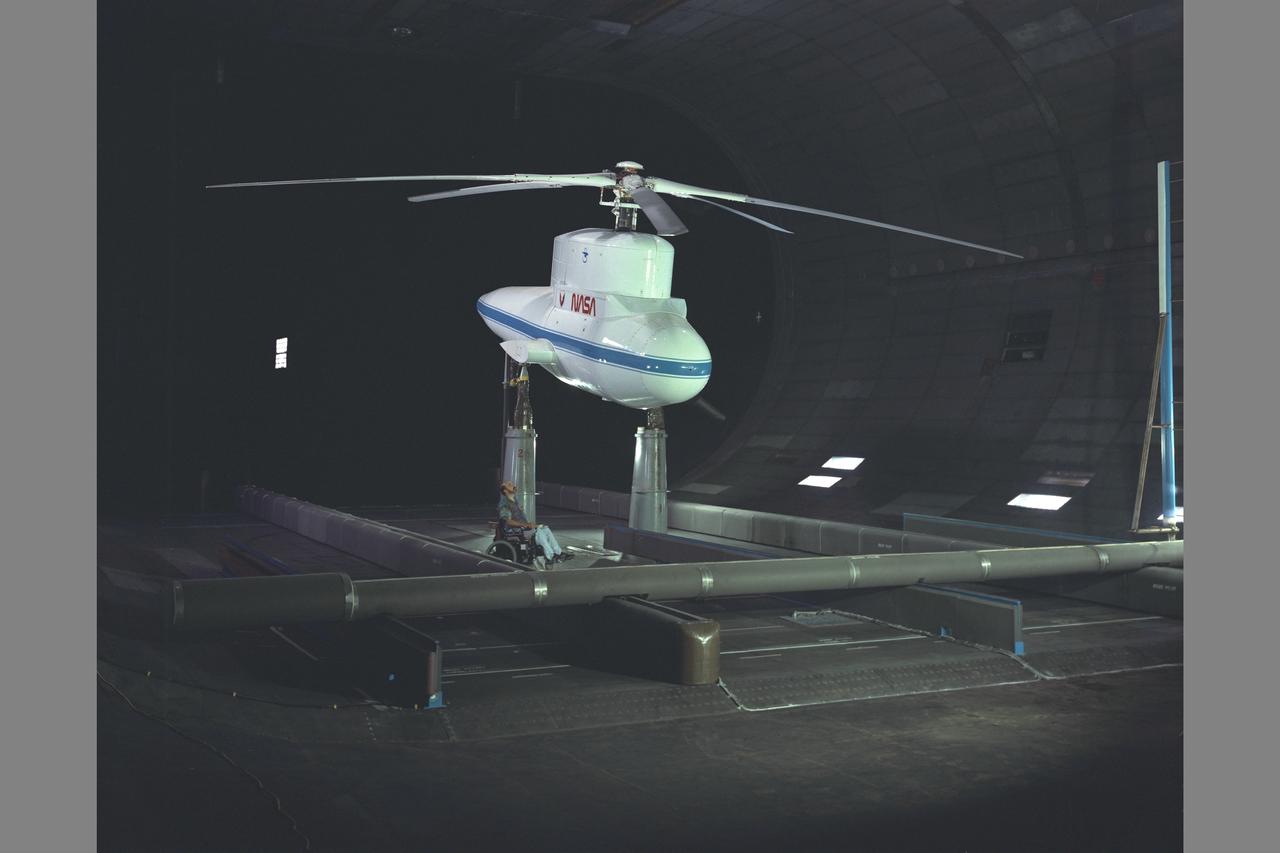 Sikorsky Bearingless Main rotor (SBMR) mounted on the Ames Rotor Test Apparatus (RTA) for testing in the NASA Ames 40x80ft Subsonic Wind Tunnel, test-584. Shown with NASA engineer Bob McMahon