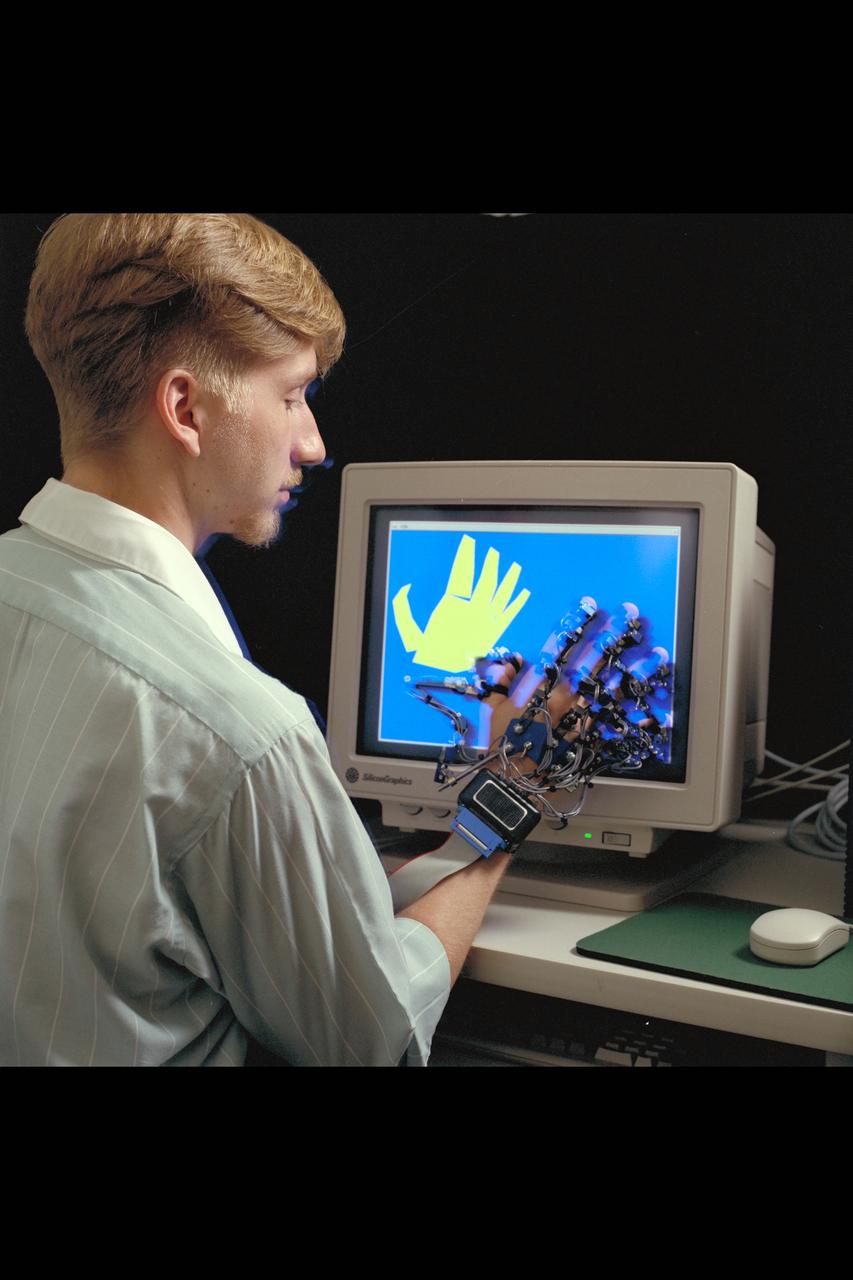 Virtual Environment Telepresence workstation, simulated Mars Exploration shows William Briggs with EXOS Dexterous interface (virtual hand)