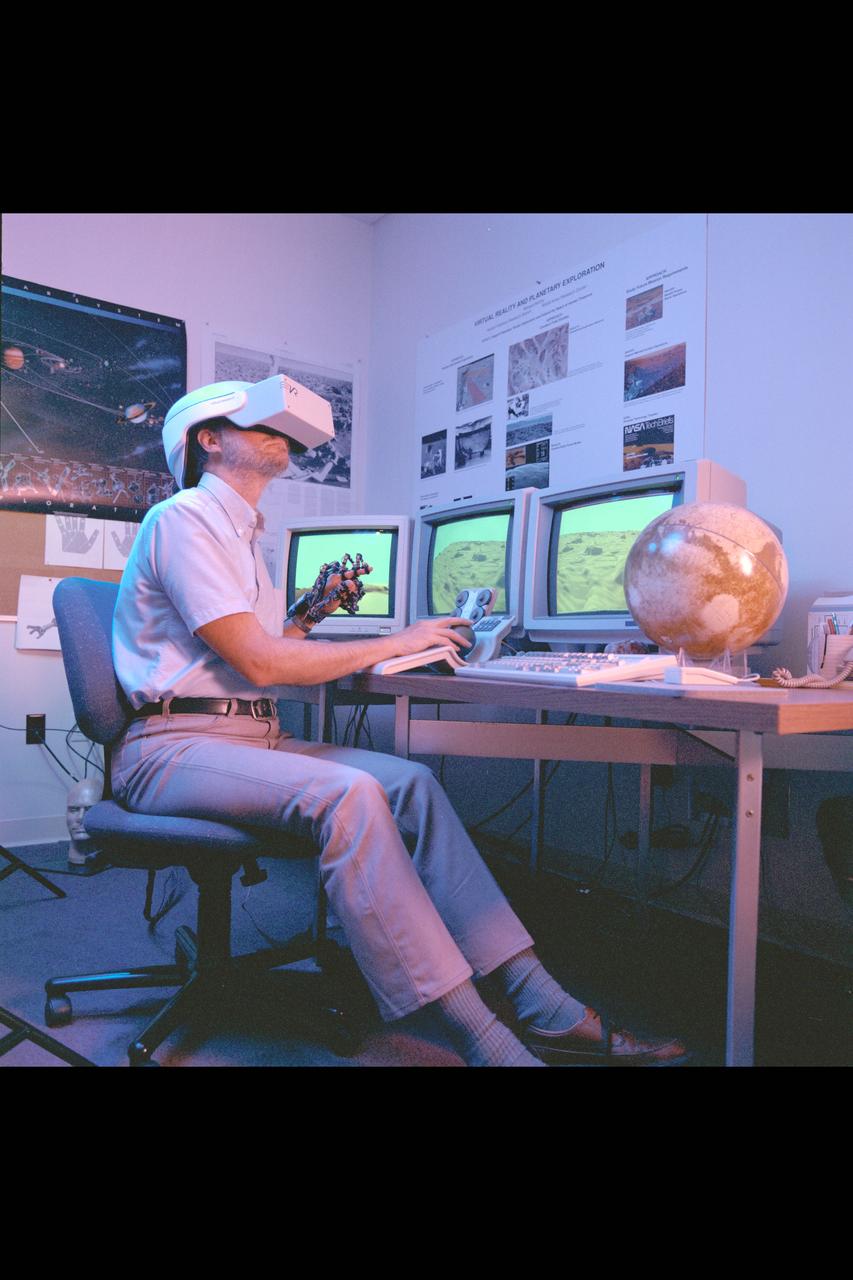 Virtual Environment Telepresence workstation, simulated Mars Exploration shows Lewis Hitchner with virtual helmet and EXOS Dexterous interface (virtual hand)