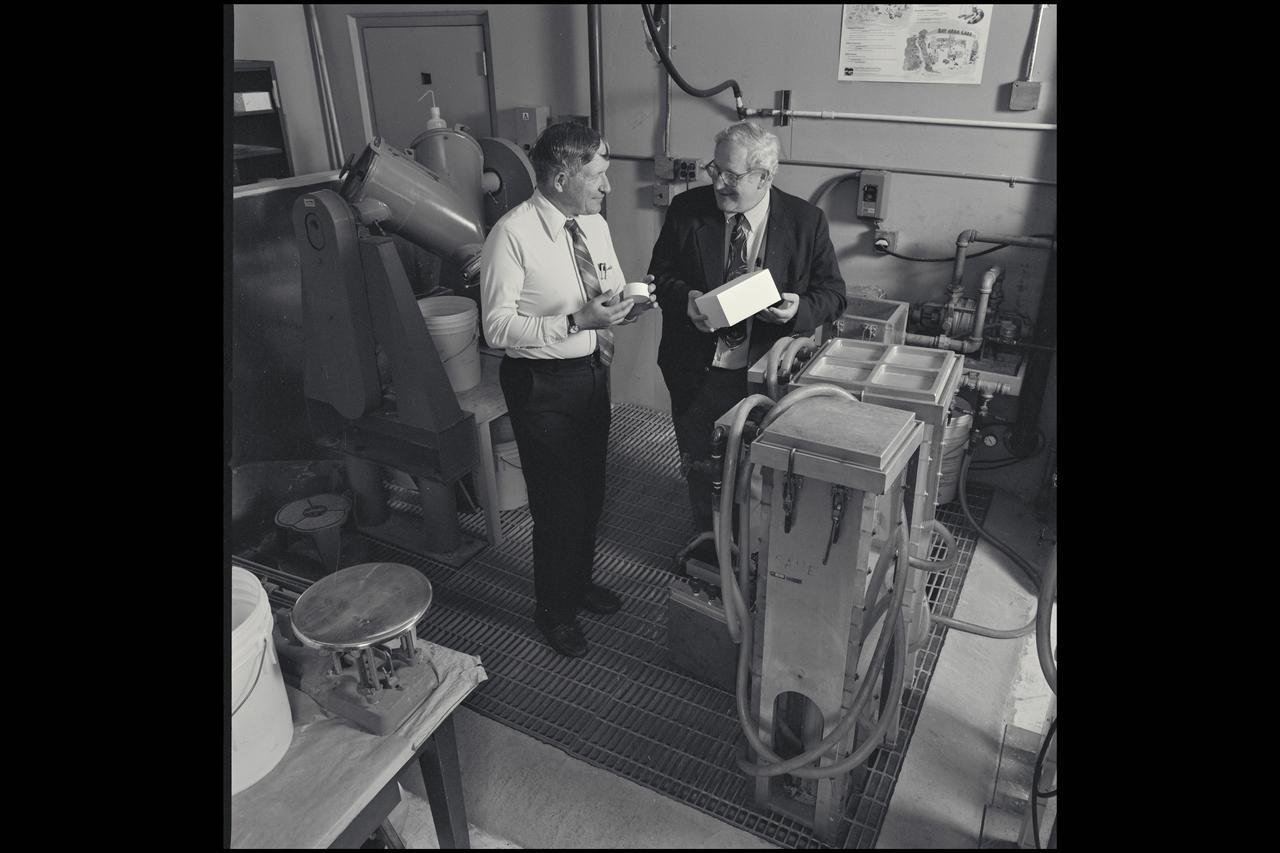 Harold Goldstein (R) and Dan Leiser (L) discuss bone implant development in the the Shuttle Tile Laboratory N-242. A spin-off of Ames research on both bone density in microgravity and on thermal protection foams is the bone-growth implant shown in 1993.