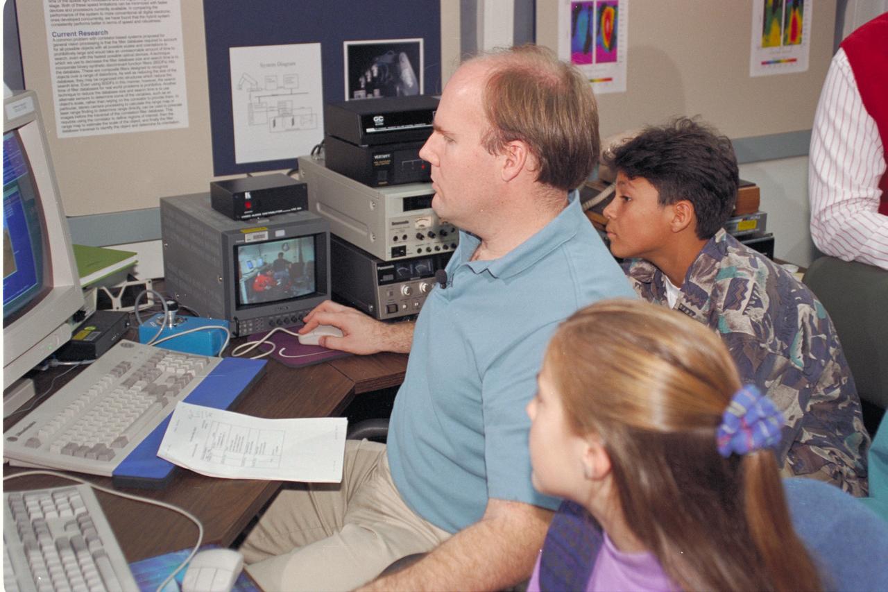 Life from other Worlds' with McNair Middle School TROV robot explores under Antarctic ice - image of Bob Hines, AMES Scientist, with Students