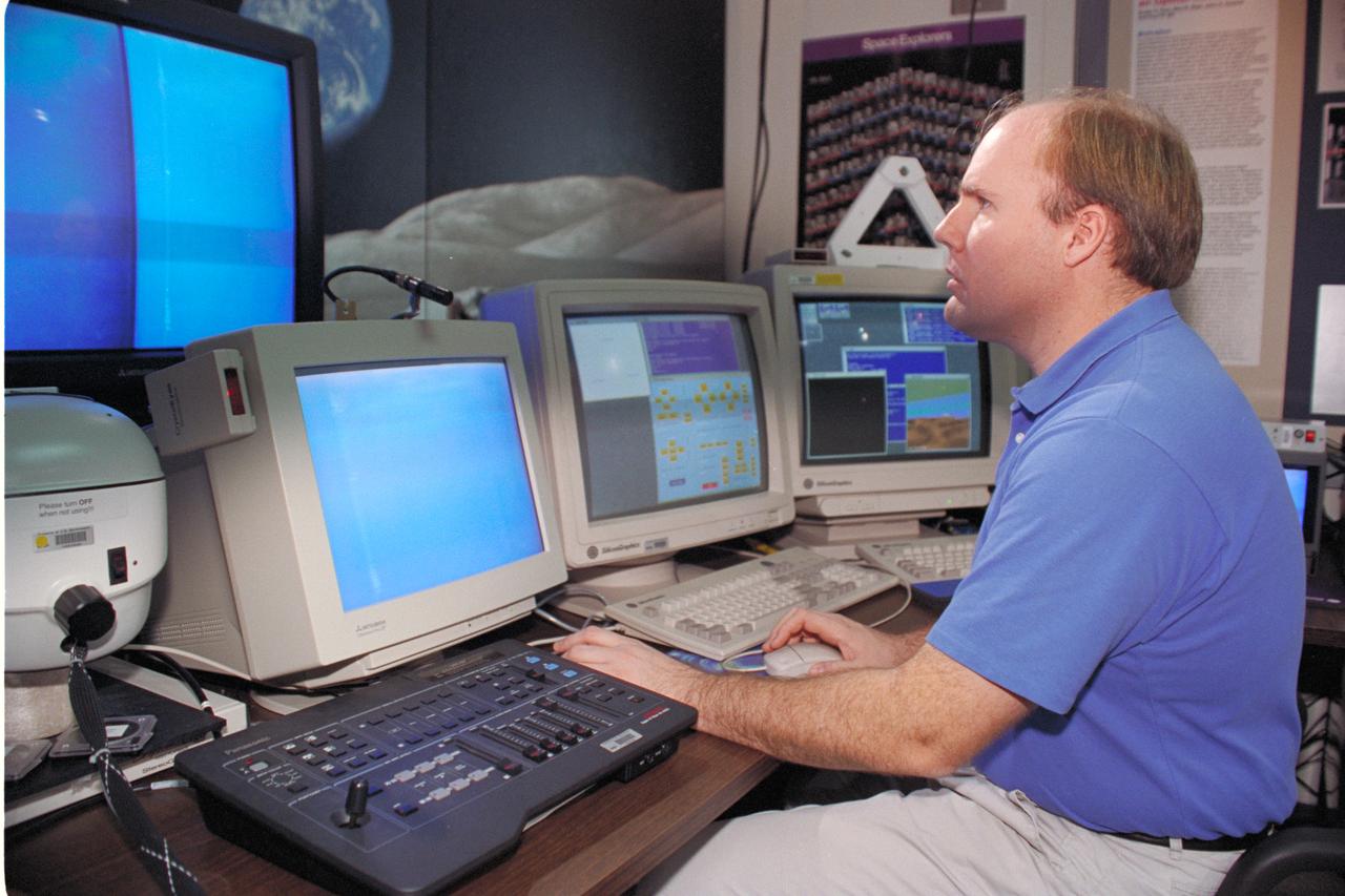'Life from other Worlds' with McNair Middle School TROV robot explores under Antarctic ice - image of Bob Hines controlling the TROV