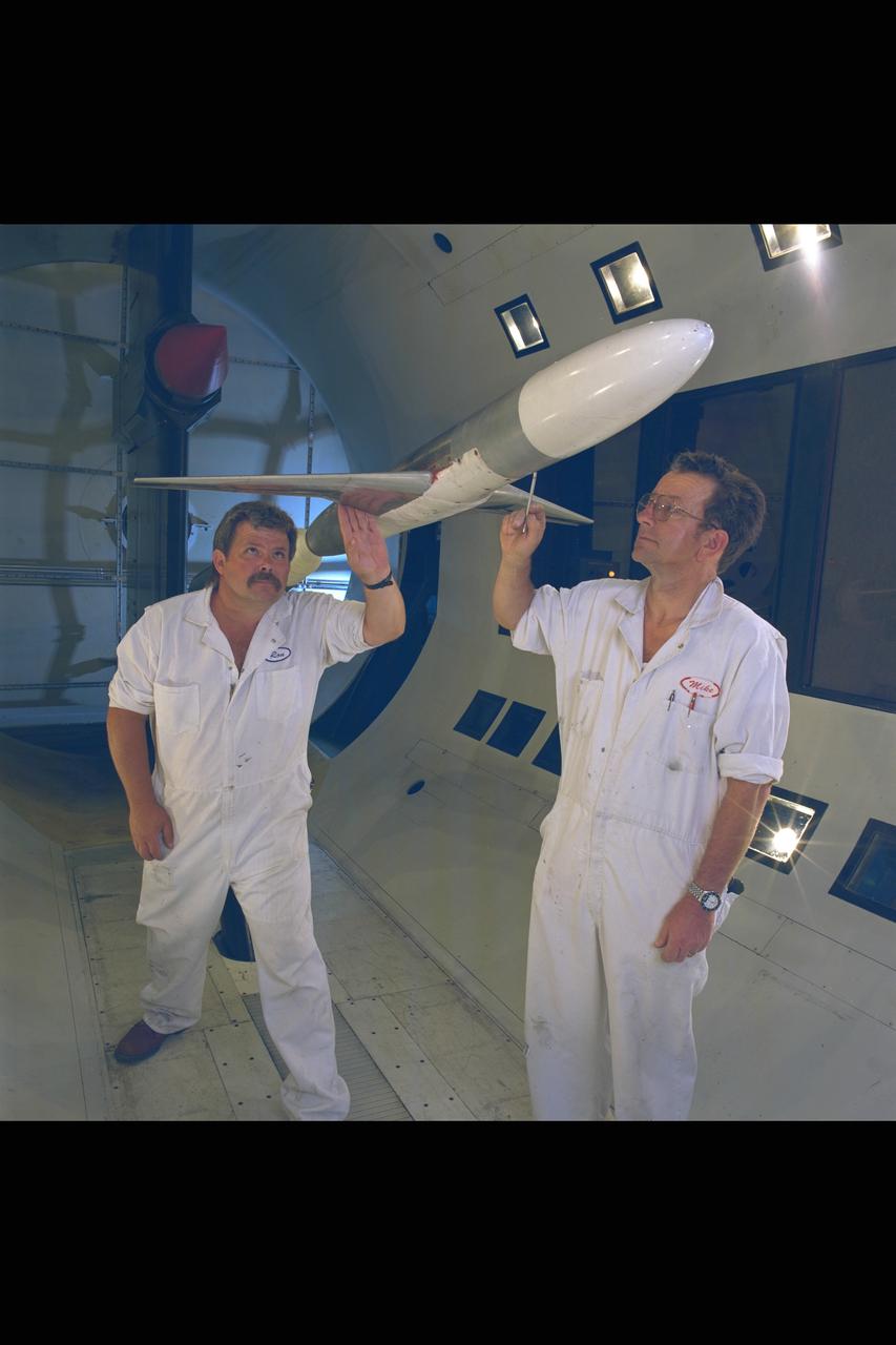 New renovated NASA Ames Research Center 12ft Pressure Wind Tunnel view of test section as 2 mechanics inspect model installation
