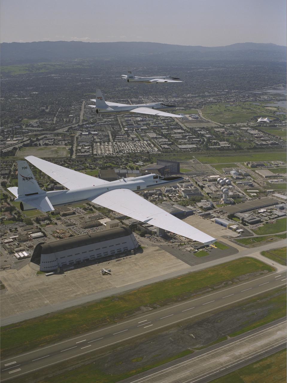 Three ER-2 Aircraft in formation over Ames Research Center, Moffett Federal Airfield , CA on their final flight before redeployment to NASA's Dryden Flight Research Center, CA
