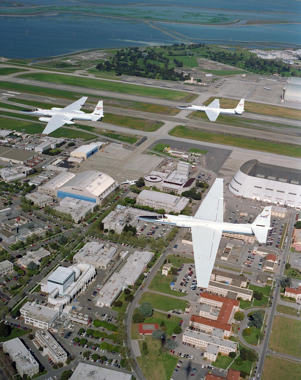 Three ER-2 Aircraft in formation over Ames Research Center, Moffett Federal Airfield , CA on their final flight before redeployment to NASA's Dryden Flight Research Center, CA