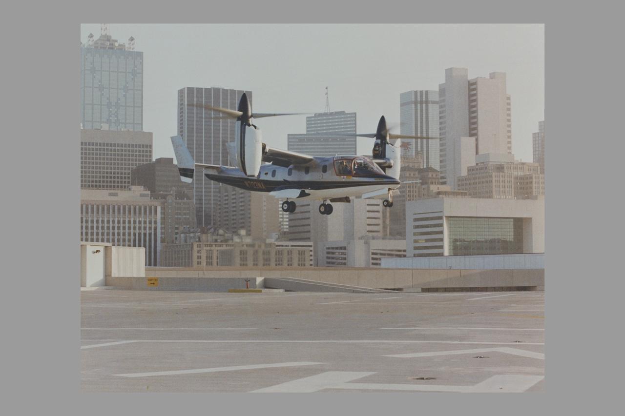 XV-15 (N703NA) Tiltrotor in hover flight landing on rooftop. Bell Photo number 042669