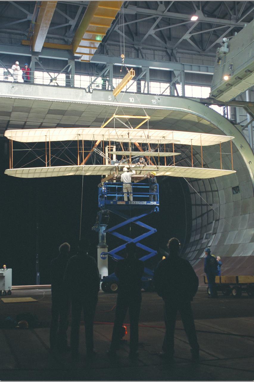 View of Installation with Pete Zell (In Cap) and Felton Smith and Richard McLimoil (In Shadows).  Wright Flyer Replica Test-40-0047:  40x80 ft. Wind Tunnel.