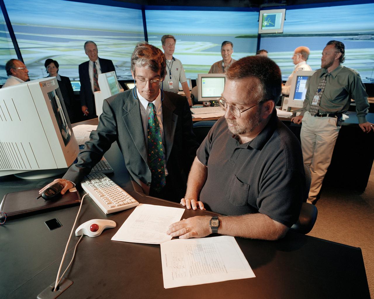 Future Flight Central (FFC) San Francisco Airport (SFO) simulation evaluation with Mathew Mead (SFO Airfield Development Bureau) and Mark Sherry (ATCT/FAA) Ames FFC staff in background