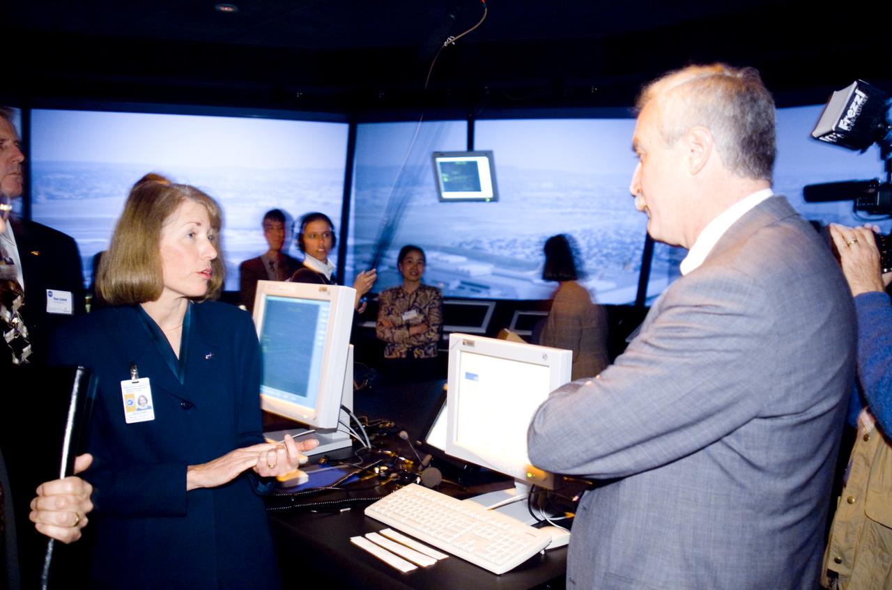 NASA Administrator Sean O'Keefe comes to Ames for employee briefing and tour. On tour FFC: Nancy Dorighi (L) breifing O'Keefe R).