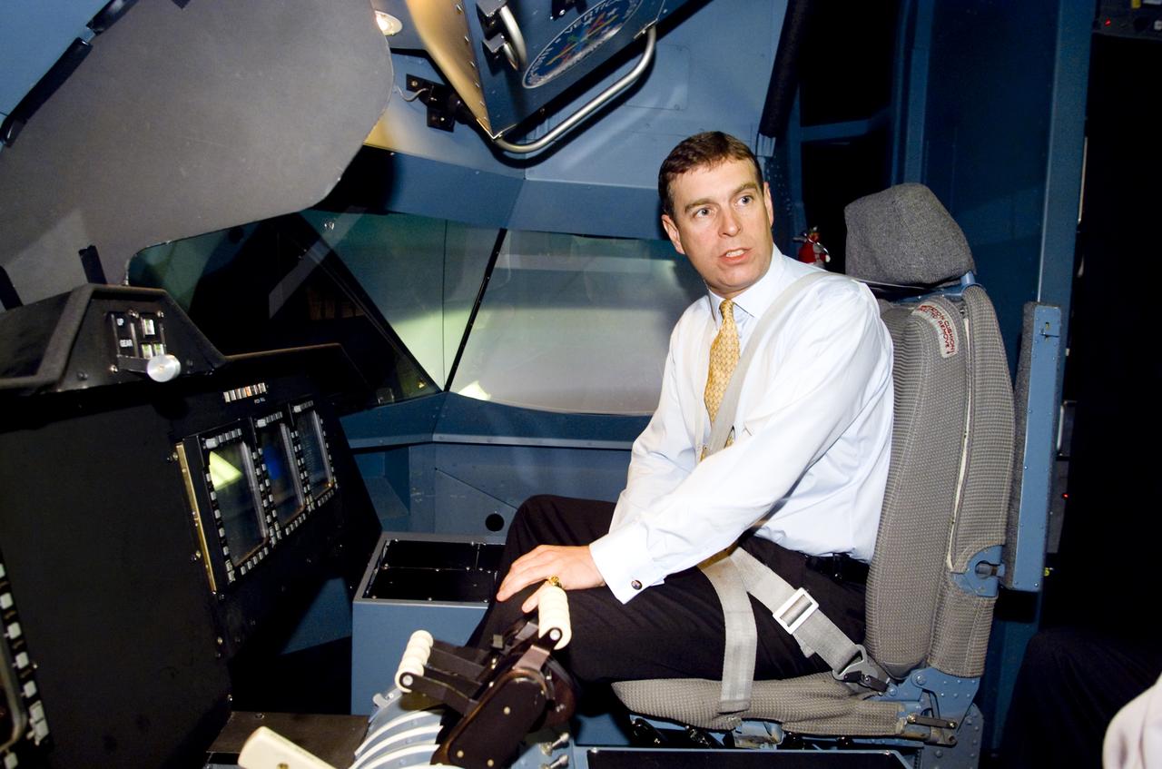 British Royalty visits Ames; Prince Andrew, Duke of York on tour. Seen here in the Vertical Motion Simulator in N-243 flying a tilt-wing simulation. (VMS)