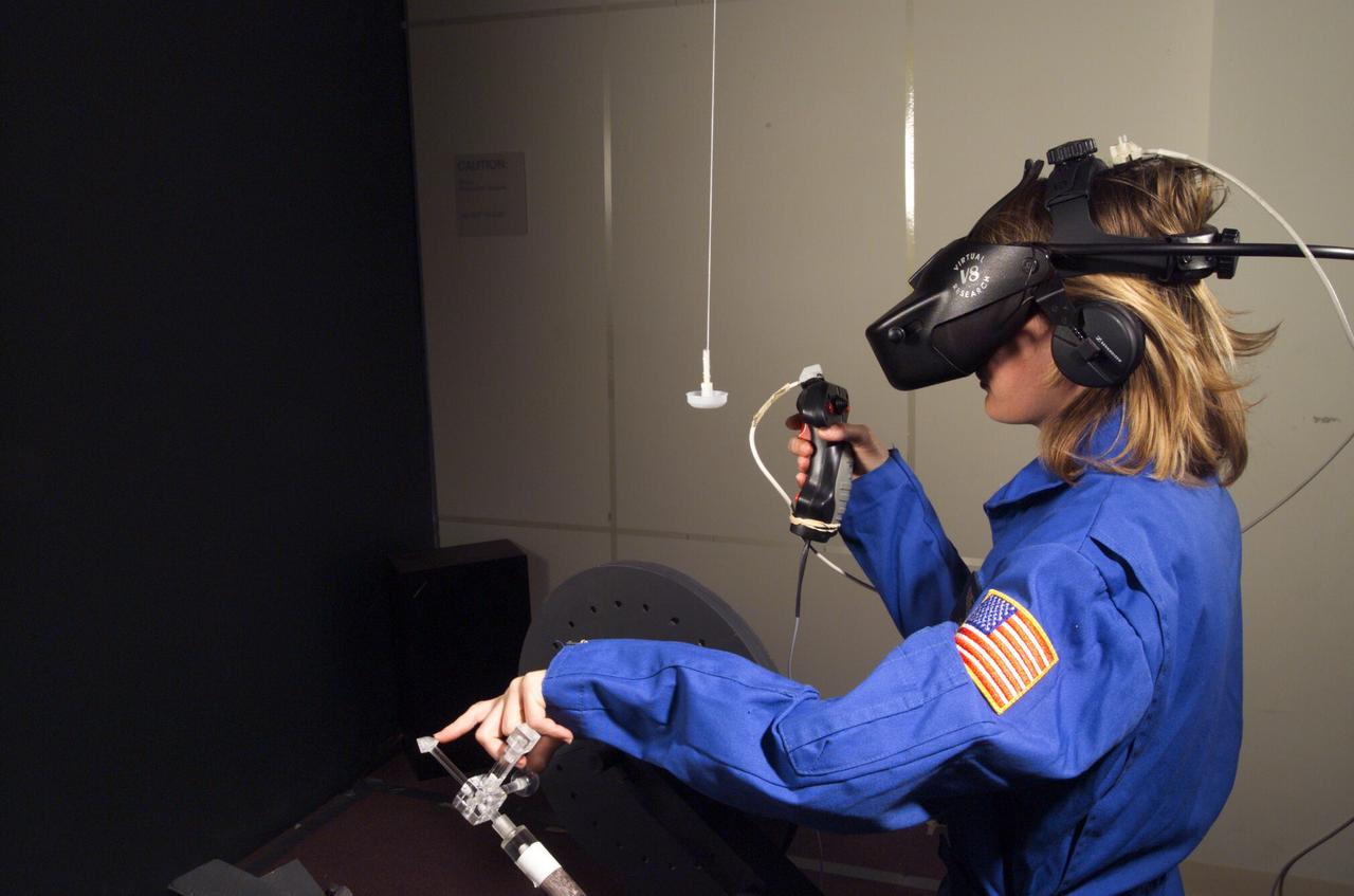 HAPTIC Cueing Research Study (p.i.: Steve Ellis) Virtual environments: Shown is Heather Smith with headgear and controls