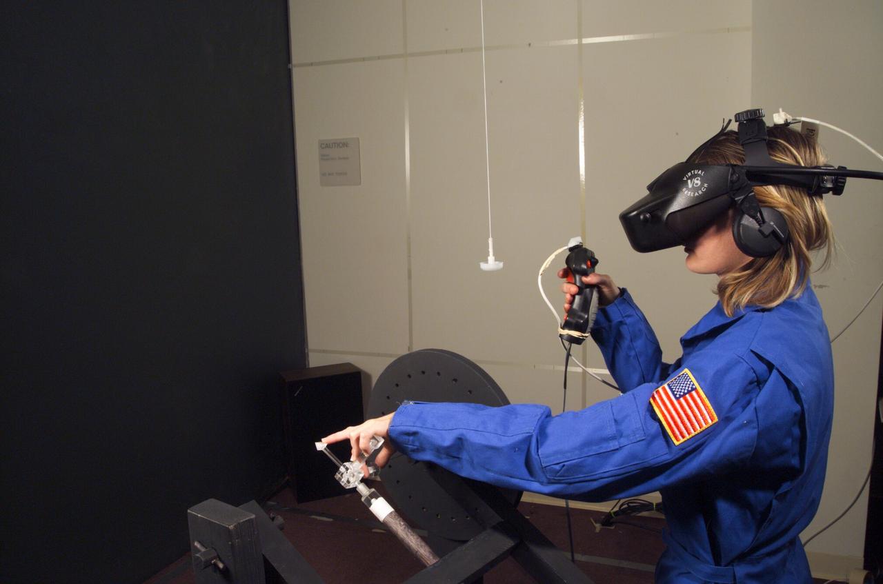 HAPTIC Cueing Research Study (p.i.: Steve Ellis) Virtual environments: Shown is Heather Smith with headgear and controls