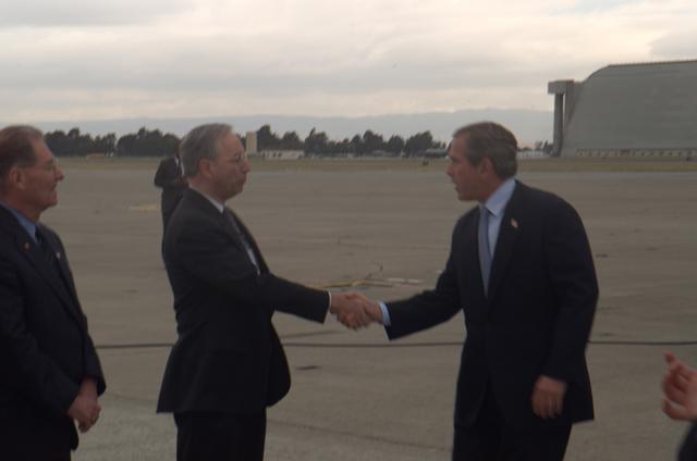 President George W. Bush lands at Moffett Field, CA.  Is greeted by  NASA Ames' Deputy Director William (Bill) Berry and NASA Ames Executive Assistant  Jack Boyd.