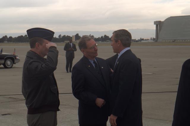 President George W. Bush lands at Moffett Field, CA.  Is greeted by Colonel James T. Williams, Cammander, 129th Rescue Wing California Air National Guard  and NASA Ames Executive Assistant  Jack Boyd
