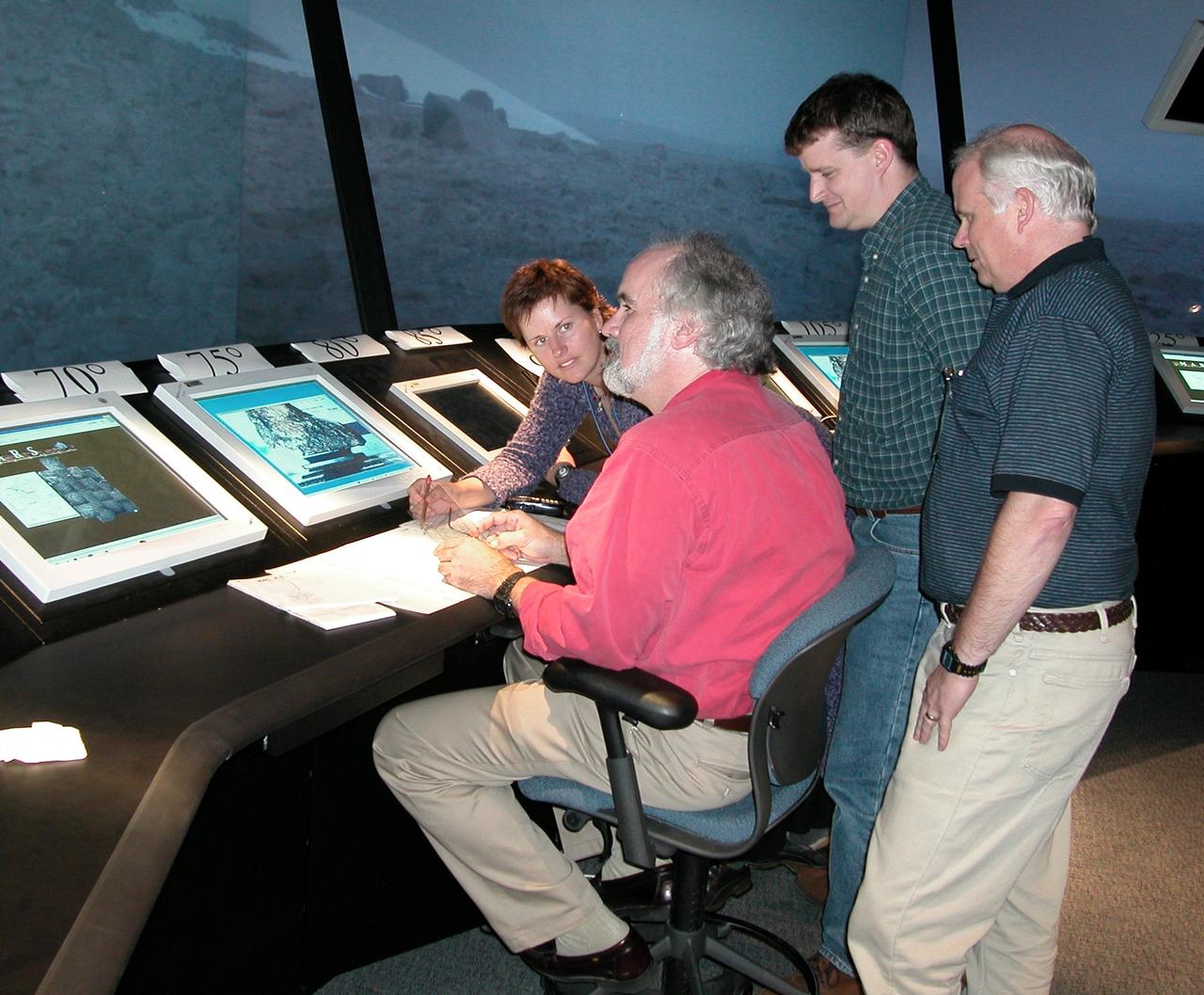 Human Robotic (Virtual) study of Houghton crater from NASA AMES Future Flight Central (FFC) Simulator tower L-R: Dr Stephen Hoffman, JSC (seated); Dr. Kelly Snook, Ames/JSC: Dr Jeffry Moersch, Univ of Tenn; and Dr Jim Saunders, Auburn
