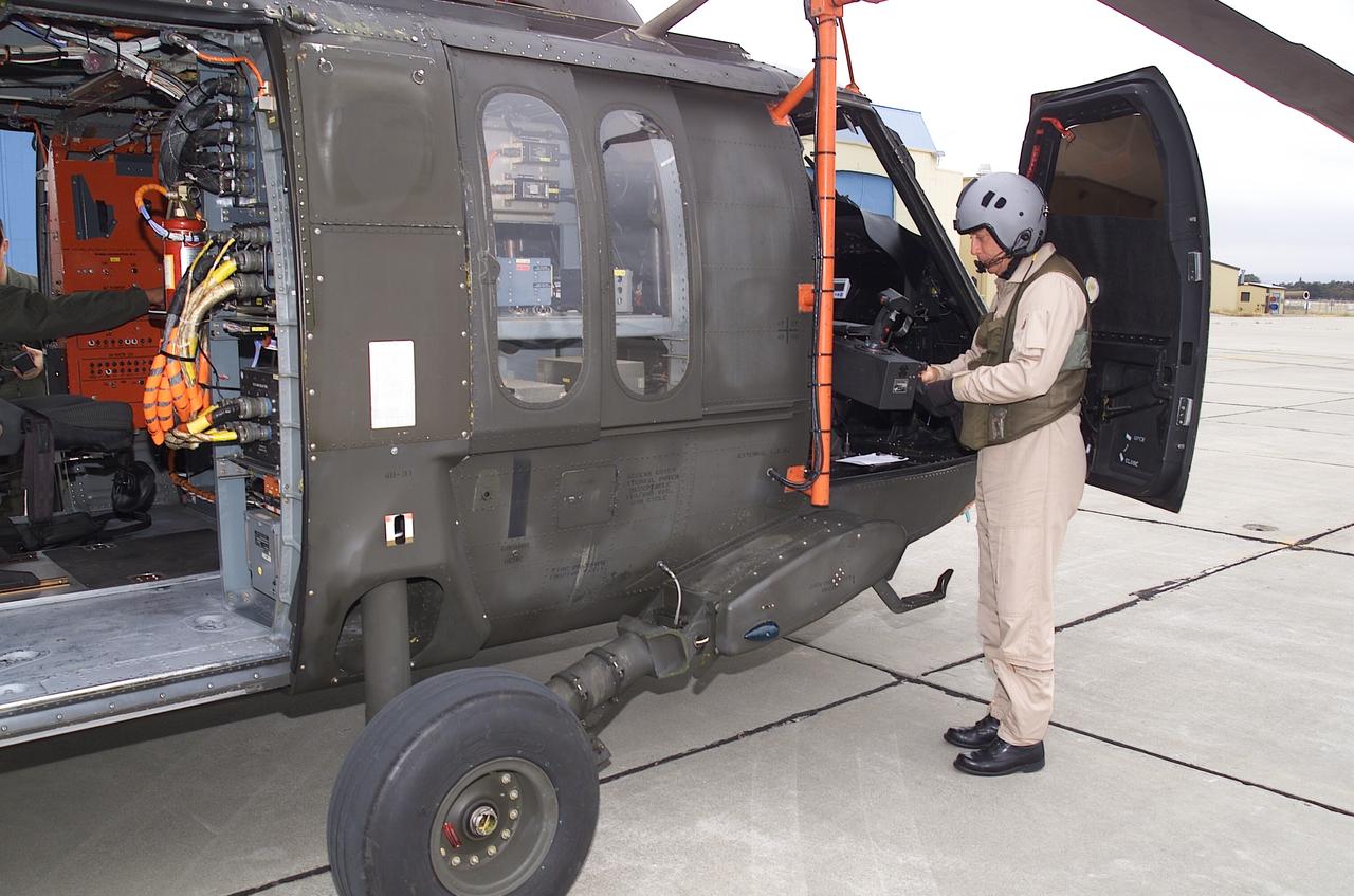 NRTC/RITA Precision Pathway Terminal Guidance: UH-60 RASCAL (#012)  (National Rotocraft Technology Center/Rotorcraft Industry Technology Association) runway independent aircraft - Sikorsky Helicopter pilot Kevin Bredenbeck preparing for flight in RASCAL with Dave Arterburn