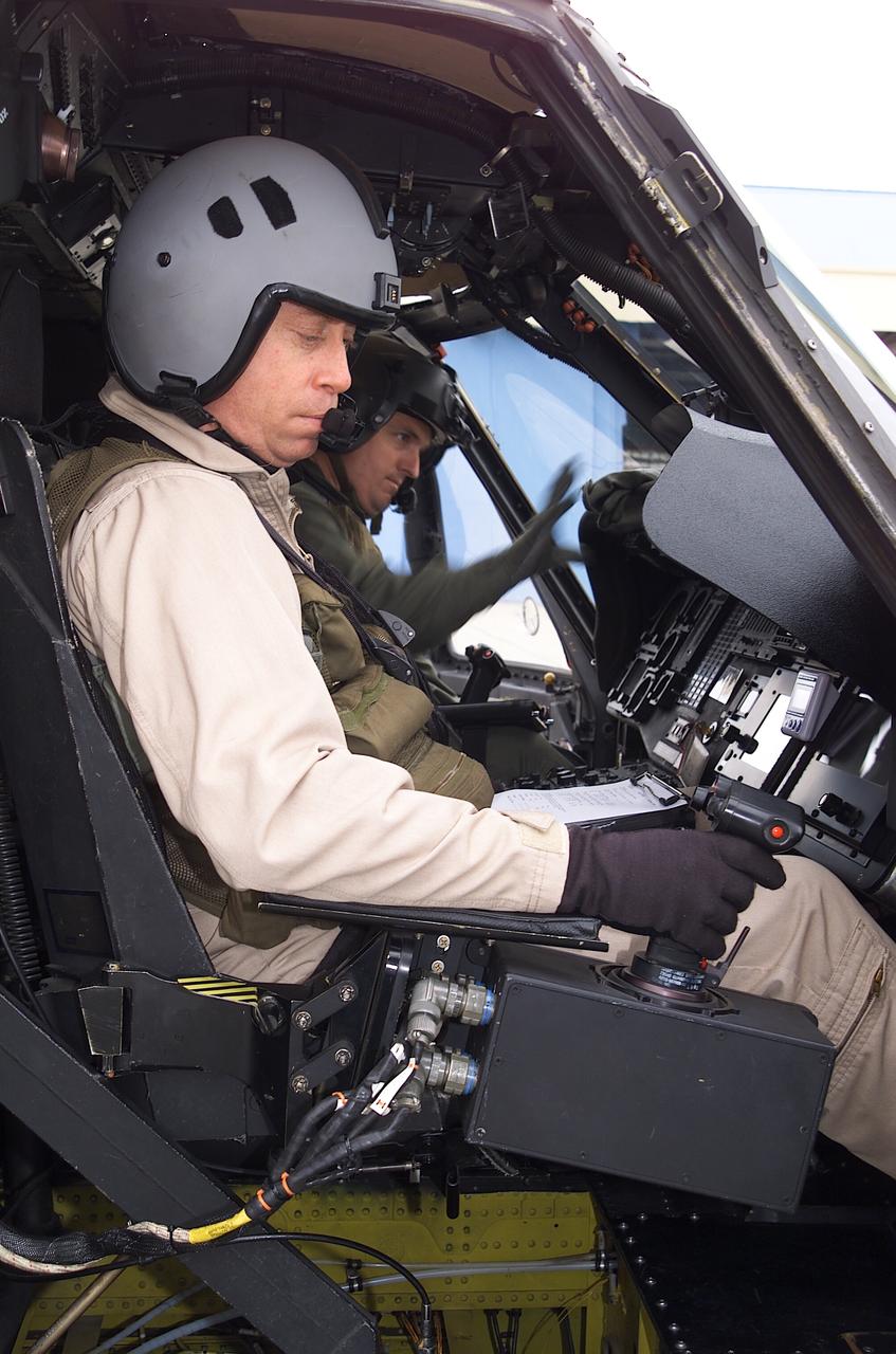 NRTC/RITA Precision Pathway Terminal Guidance: UH-60 RASCAL (#012)  (National Rotocraft Technology Center/Rotorcraft Industry Technology Association) runway independent aircraft; Sikorsky Helicopter pilot Kevin Bredenbeck preparing for flight in RASCAL with Dave Arterburn