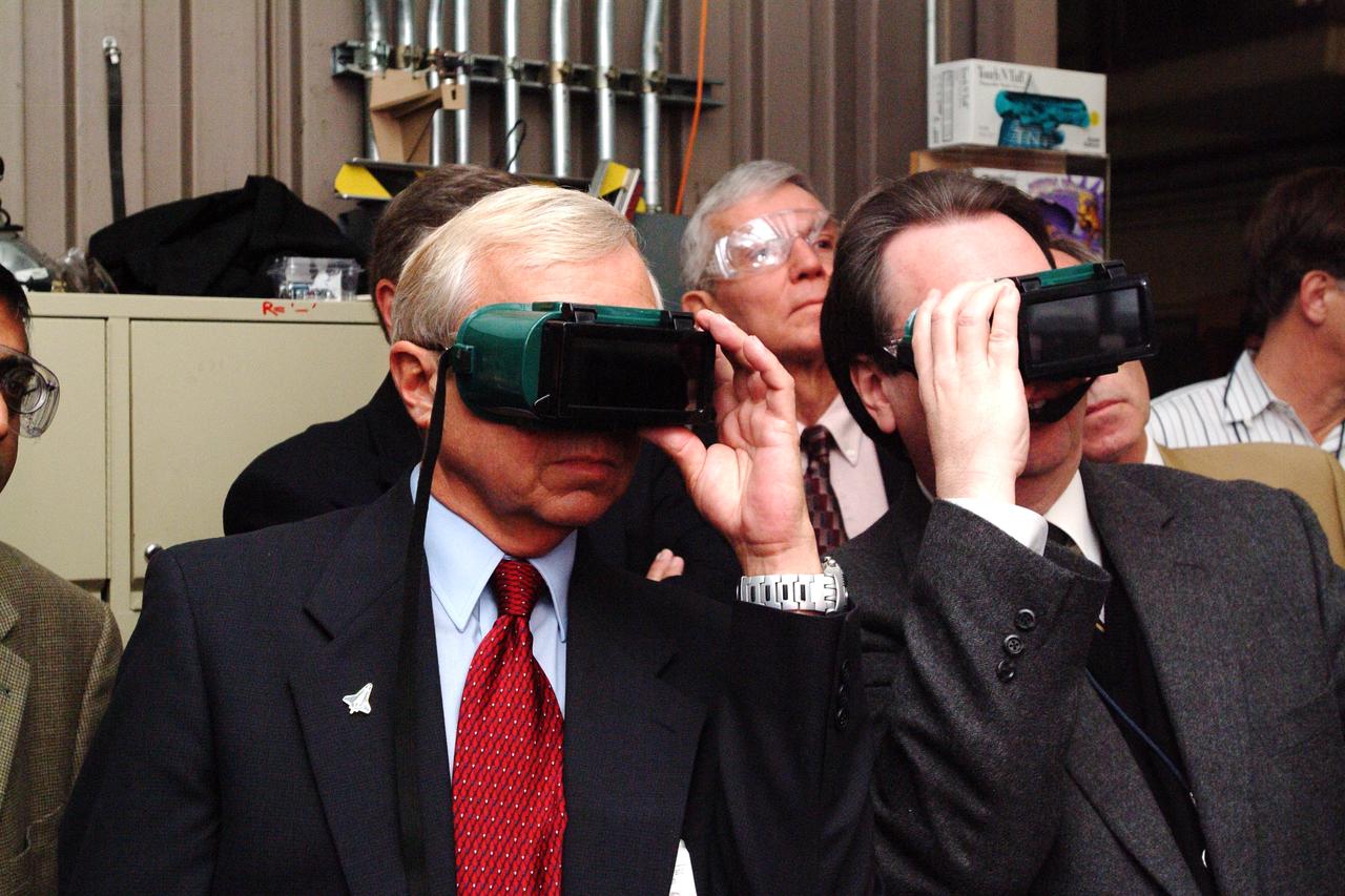 NASA Space Science Advisory Committee Chairman Ed Wiler (r) visit to Ames Research Center: on tour of the Arc Jet Facility with G. Scott Hubbard, Raj Venkatapathy and entourage.  Wiler and Hubbard use special viewing glasses to observe a test run of Thermal Protection Materials.