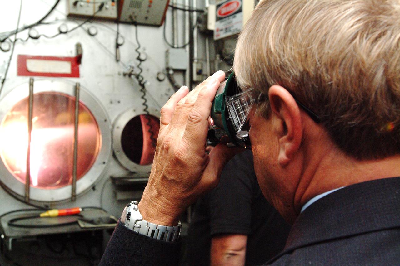 NASA Space Science Advisory Committee Chairman Ed Wiler (r) visit to Ames Research Center: while on tour of the Arc Jet Facility with G. Scott Hubbard, Raj Venkatapathy and entourage.  Wiler uses special viewing glasses to observe a test run of Thermal Protection Materials.