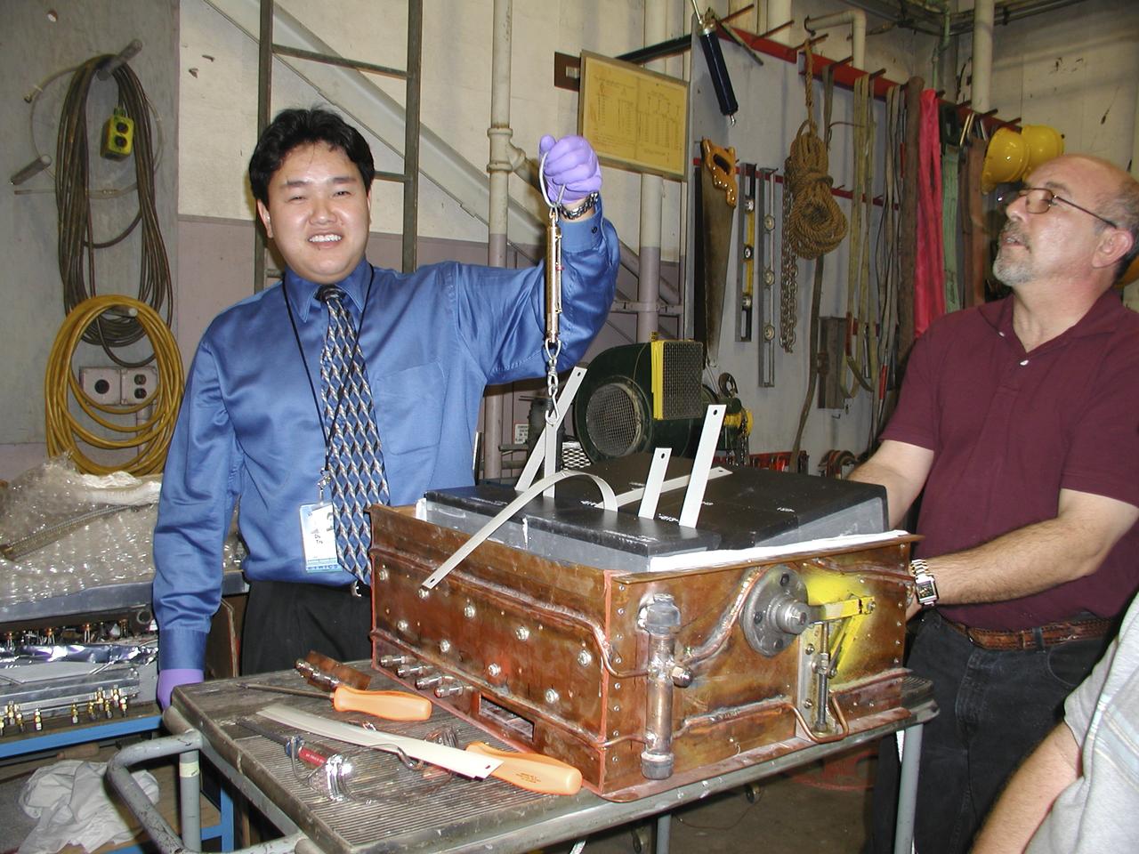 Thermal Evaluaion of X-37 Body Flap Sea test in Panel Test Facility PTF-115 with (l) Duoc Tran, Boeing Test engineer and (r) Vincent Meglio, NASA lead Engineering Technician / Operator