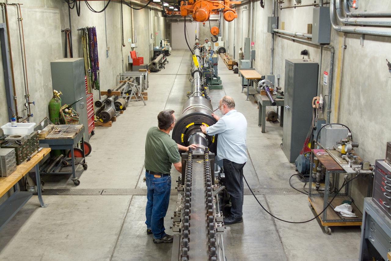 Overview of the light gas gun in the Ames Hypersonic Free Flgiht Aerodynamic Facility (HFFAF) with Don Bowling (l), Don Holt (r) and Rick Smythe (bkgrd).
