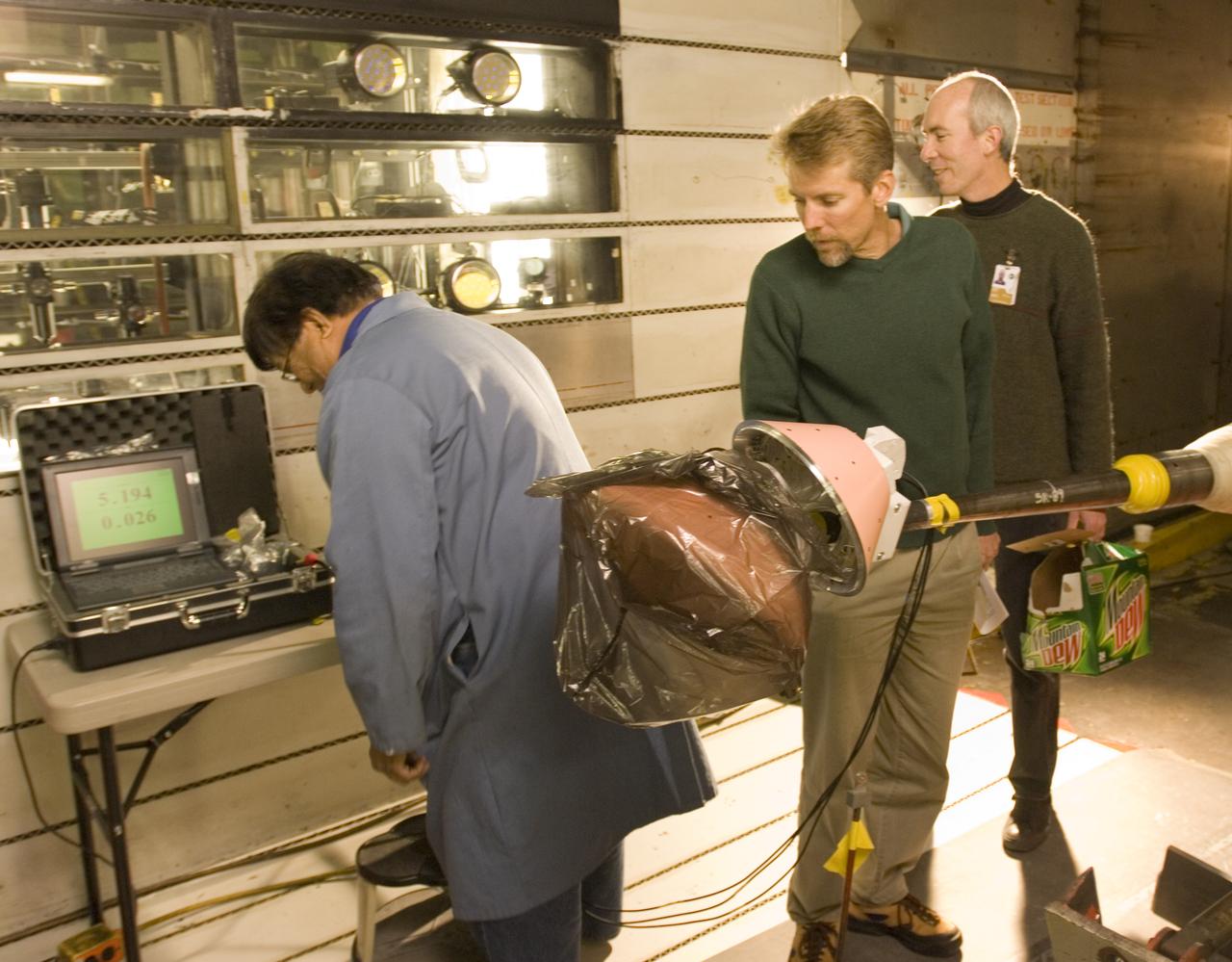 CEV model with pressure sensitive paint (PSP) test 11-0148 in the 11ft Ames wind tunnel. Shown here with Danny Ompoc (l), Bruce Stroms (m) and James Bell (r).