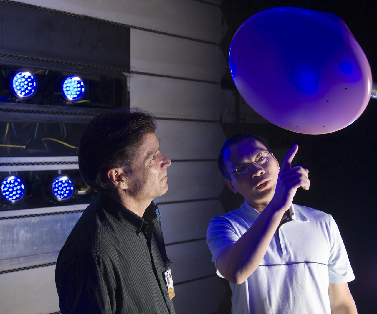 CEV model with pressure sensitive paint (PSP) test 11-0148 in the 11ft Ames wind tunnel. Shown here with Paul Espinosa (l) and Tuan Truong (r) wwith blue LEDS