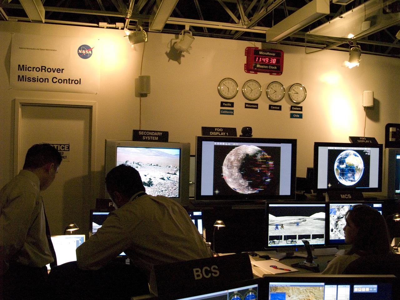 Spaceward Bound Program in Atacama Desert; shown here is a realtime webcast from Yungay, Chile vis satellite involving NASA Scientists and seven NASA Explorer school teachers. On the Ames end we find the Girl Scouts Space cookines robotic team. The robot nicknamed Zoe is looking for life in extreme environments in preparation for what might be encounter on Mars. see full text on the NASA-Ames News - Research # 04-91AR