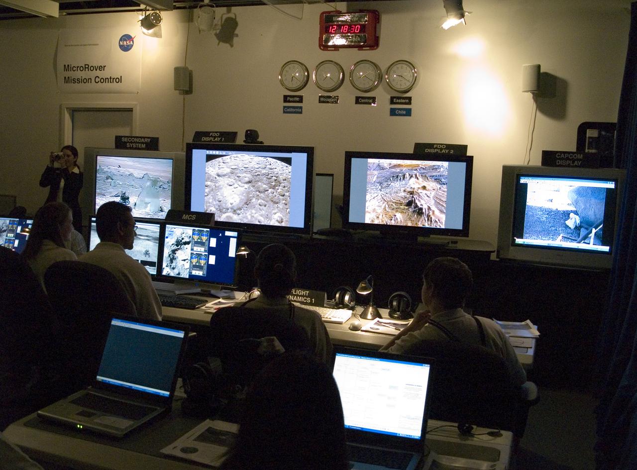 Spaceward Bound Program in Atacama Desert; shown here is a realtime webcast from Yungay, Chile vis satellite involving NASA Scientists and seven NASA Explorer school teachers. On the Ames end we find the Girl Scouts Space cookines robotic team. The robot nicknamed Zoe is looking for life in extreme environments in preparation for what might be encounter on Mars. see full text on the NASA-Ames News - Research # 04-91AR