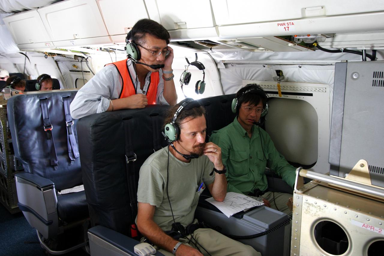 DC-8 NAMMA MISSION TO CAPE VERDE, AFRICA: Principlal investigator Eastwood Im (l), co-principal investigator Simone Tanelli (c )and RF Engineer William Chun (r) of JPL look at data coming off their APR-2 (Airborne 2nd Generation Precipitation Radar) instrument onboard NASA's DC-8 during a NAMMA science flight