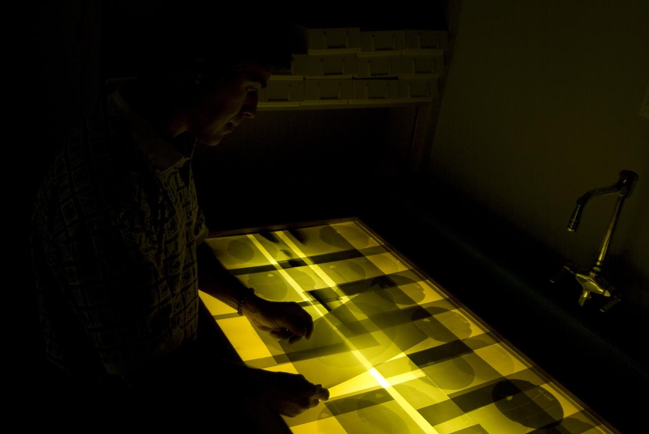 CEV (Crew Escape Vehicle) capsule Balistic Range testing to examine static and dynamic stability characteristics  (at the Hypervelocity Free-Flight Facility) HFF - Chuck Cornelison viewing 8x10 shadowgraph images