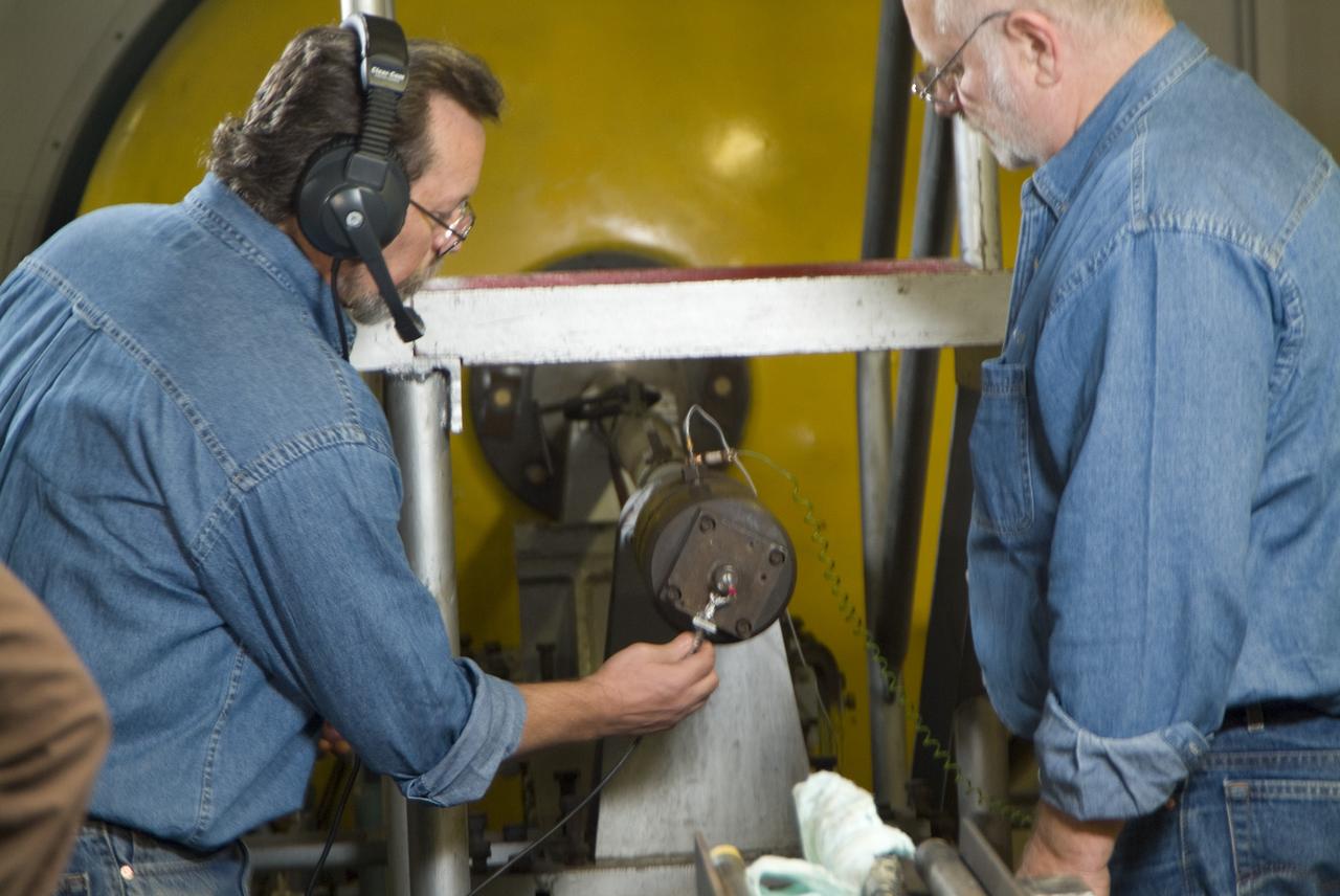 CEV (Crew Escape Vehicle) capsule Balistic Range testing to examine static and dynamic stability characteristics  (at the Hypervelocity Free-Flight Facility) HFF - Don Bowling (l) attaching firing cable to breeth cap as Don Holt (r) looks on