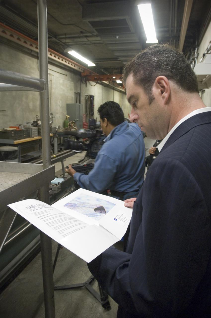 Ames holds a Media Day at the Hypervelocity Free Flight facility where Ames is conducting high-speed tests of small models of the agency's new Orion CEV  to learn about stability during flight. The hypervelocity test facility uses a gun to shoot Orion models between 0.5 and l.5 inches (1.25 - 3.75 centimeters in diameter. The facility can conduct experiments with speeds up to 19,000 miles per hour (30,400 kilometers per hour) - NBC Channel 11 Technology/Business reporter Scott Budman at the gun range (w/C Acosta in bkgrd)