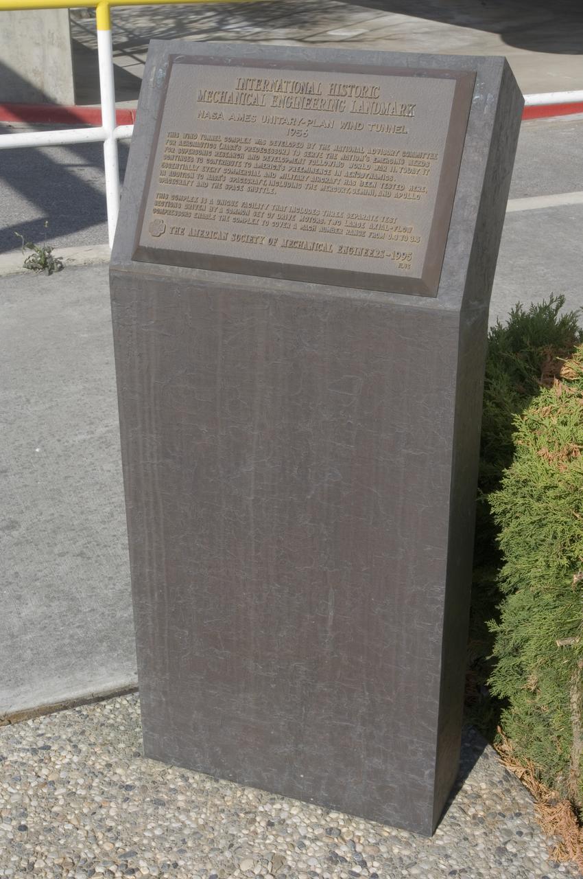 Ames and Moffett Field (MFA) historical sites and memorials Unitary Plan Wind Tunned plaza; display and historical site plaques with the NASA logo on the Wind Tunnel valve as a backdrop.  shown is the Unitary International Historic Mechanical Engineering Landmark Dedication plaque (American Society of Mechanical Engineers) May 5, 1995