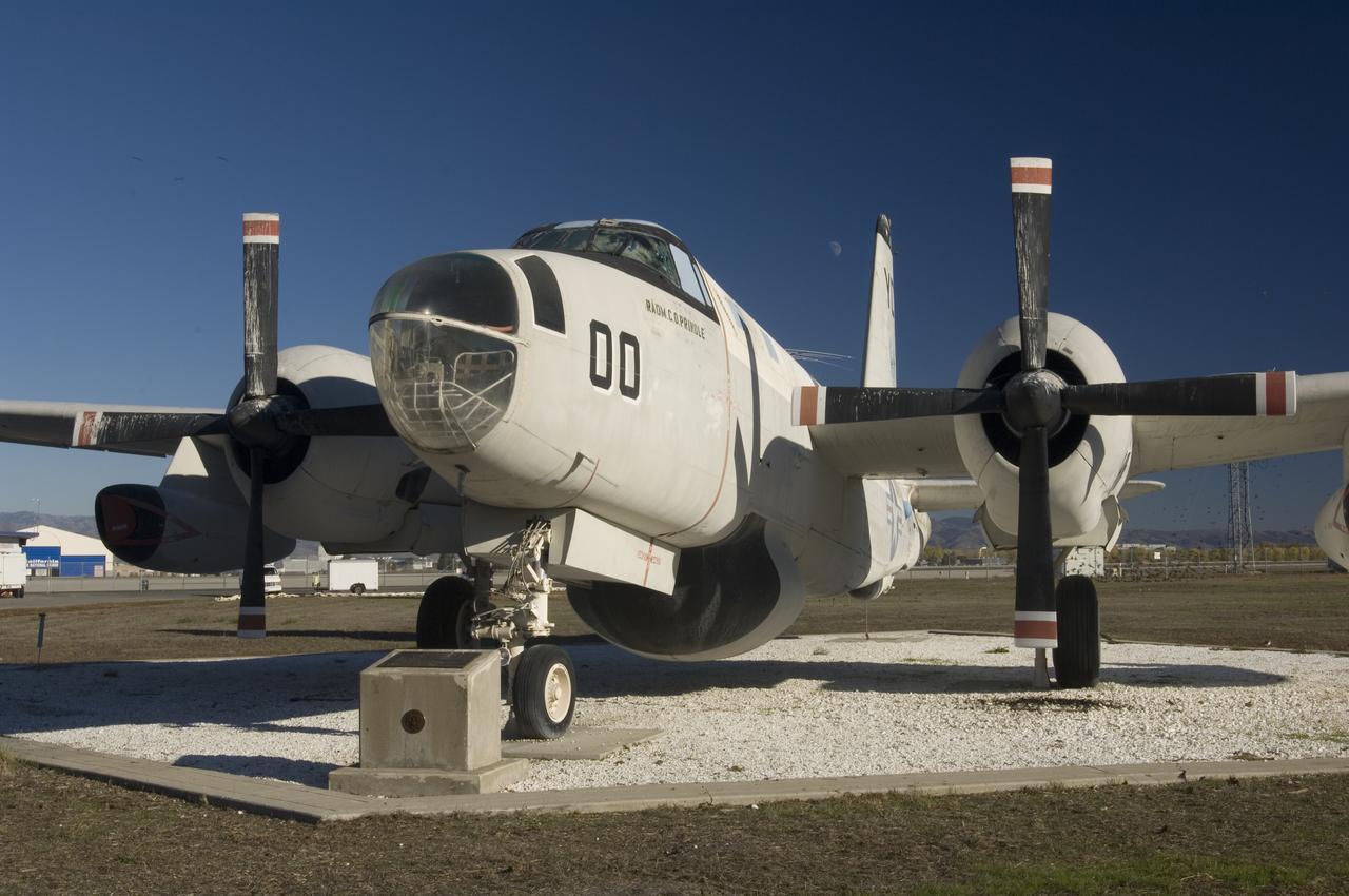 Ames and Moffett Field (MFA) historical sites and memorials Navy Lockheed SP-2E Neptune Long Range Antisubmarine Partol Aircraft on display in front of MFA Bldg 158 Flgiht Ops (tower) with monuments