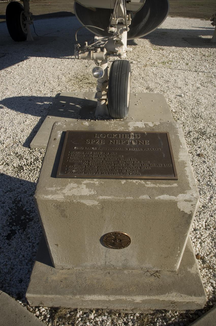 Ames and Moffett Field (MFA) historical sites and memorials Navy Lockheed SP-2E Neptune Long Range Antisubmarine Partol Aircraft on display in front of MFA Bldg 158 Flgiht Ops (tower) with monuments